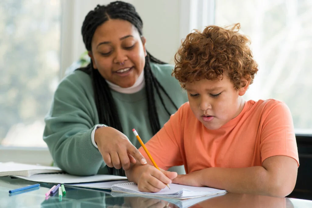 A-tutor-helping-a-young-person-study-1024x684